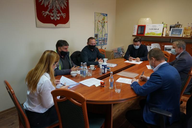 Zastępca Burmistrza wraz z Dyrektorem Wydziału Finansowo- Podatkowego i Wykonawcami podpisują umowę. Obecni pracownicy Urzędu.